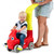 Parent pushing toddler in ride-on that can be push or foot powered