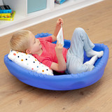 young boy curled up reading with a pillow in extra large wobble disk