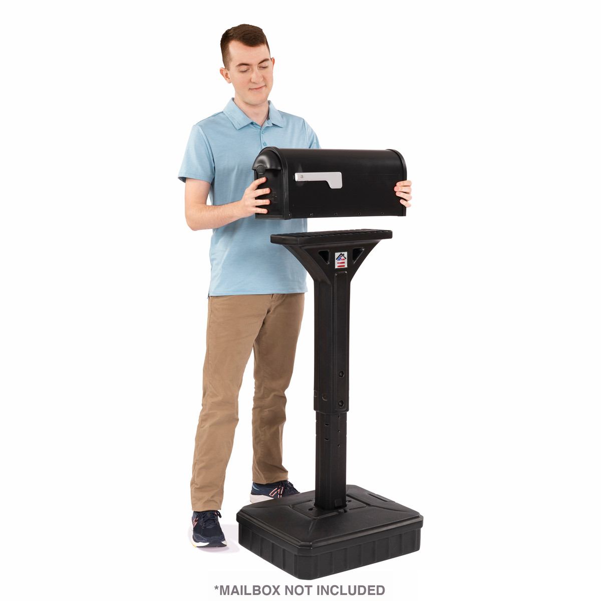 Man placing mailbox onto dig free mailbox post in black