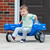 Toddler boy seated riding in the Simplay3 Galaxy Glider in a driveway