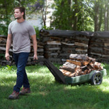 Man hauling firewood with Simplay3 American Home Flat Bed Cart